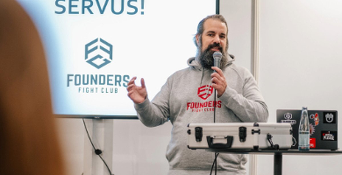 Jan Küster hebt ein Mikrofon in der Hand uns spricht